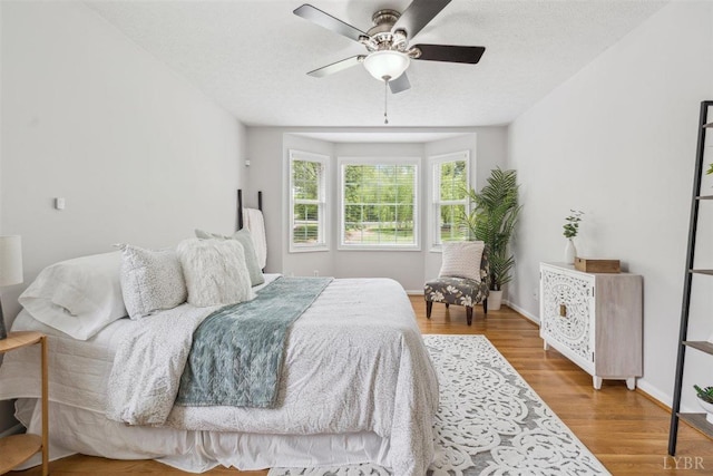 112 Cedarwood Ct, Forest, VA 24551 - bedroom with wood finished floors, ceiling fan, a textured ceiling, and baseboards