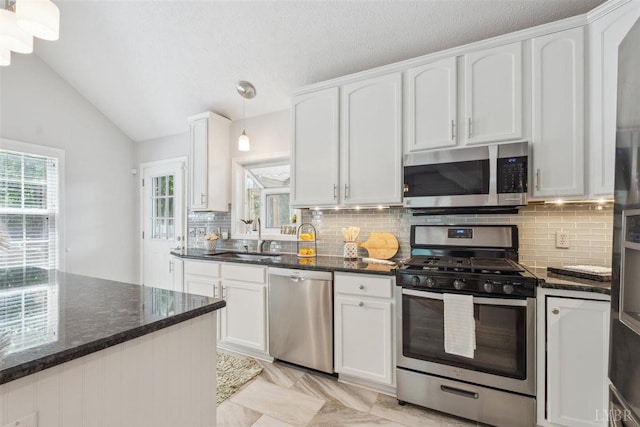 112 Cedarwood Ct, Forest, VA 24551 - kitchen with appliances with stainless steel finishes, a sink, white cabinets, dark stone counters, and vaulted ceiling