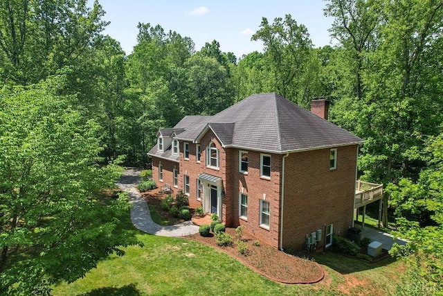 4936 Mountain Laurel Dr, Lynchburg, VA 24503 - view of front of house with a chimney, a front yard, brick siding, and a view of trees