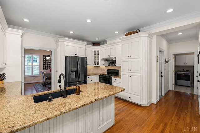 4936 Mountain Laurel Dr, Lynchburg, VA 24503 - kitchen with black appliances, a sink, under cabinet range hood, a peninsula, and light stone counters