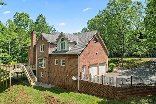 4936 Mountain Laurel Dr, Lynchburg, VA 24503 - view of side of property with stairs, a deck, brick siding, a chimney, and asphalt driveway