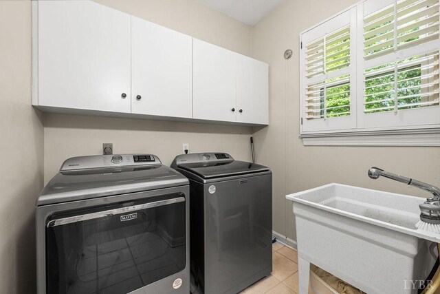 4936 Mountain Laurel Dr, Lynchburg, VA 24503 - washroom featuring independent washer and dryer, cabinet space, and light tile patterned floors