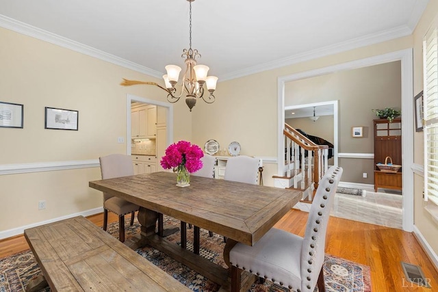 4936 Mountain Laurel Dr, Lynchburg, VA 24503 - dining area with a chandelier, light wood finished floors, crown molding, stairs, and baseboards