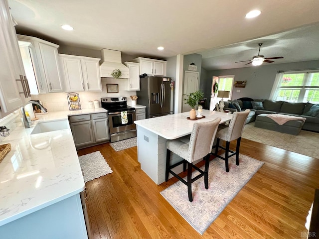 605 Beeks Ln, Spout Spring, VA 24593 - kitchen featuring stainless steel appliances, a sink, custom exhaust hood, a breakfast bar area, and a ceiling fan