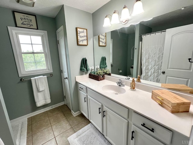 605 Beeks Ln, Spout Spring, VA 24593 - full bath featuring vanity, toilet, tile patterned flooring, baseboards, and a textured ceiling