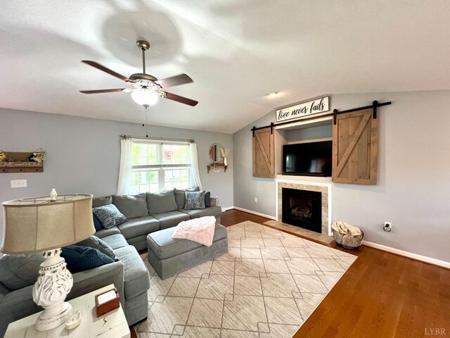 605 Beeks Ln, Spout Spring, VA 24593 - living room featuring a barn door, a ceiling fan, lofted ceiling, baseboards, and light wood finished floors