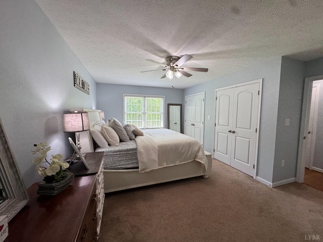 605 Beeks Ln, Spout Spring, VA 24593 - carpeted bedroom with two closets, a textured ceiling, ceiling fan, and baseboards