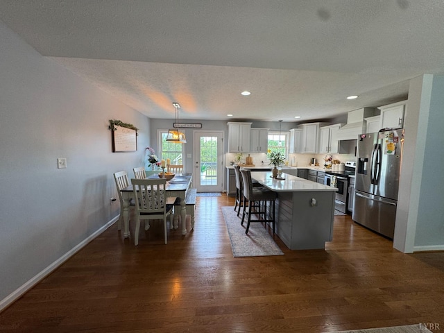 605 Beeks Ln, Spout Spring, VA 24593 - kitchen with stainless steel appliances, dark wood finished floors, baseboards, a kitchen island, and white cabinets