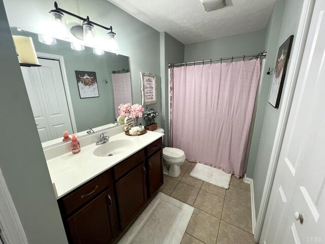 605 Beeks Ln, Spout Spring, VA 24593 - full bath featuring vanity, toilet, a textured ceiling, tile patterned flooring, and curtained shower