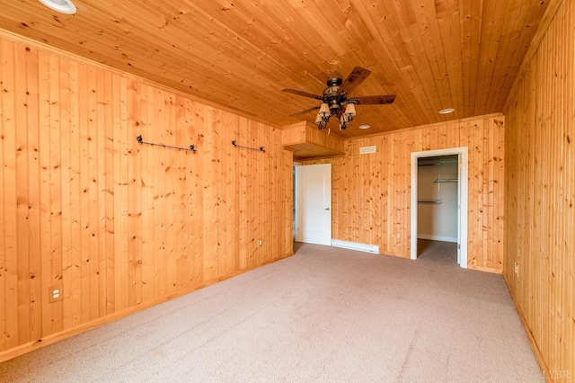 126 Golf Course Trl, Amherst, VA 24521 - unfurnished bedroom with wood ceiling, wood walls, carpet, a spacious closet, and a ceiling fan