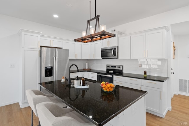 71 Patrick Ct, Madison Heights, VA 24572 - kitchen featuring stainless steel appliances, white cabinetry, light wood finished floors, tasteful backsplash, and recessed lighting