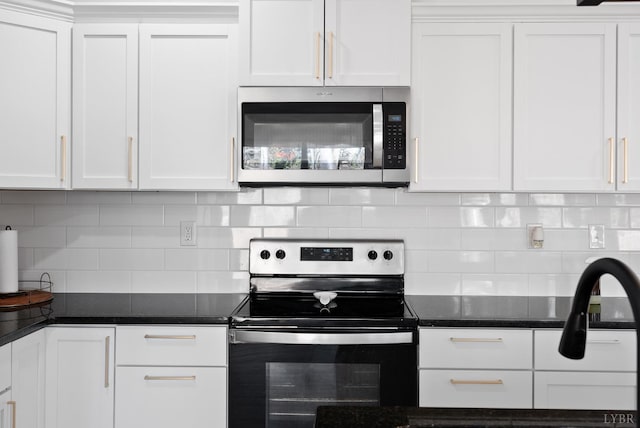 71 Patrick Ct, Madison Heights, VA 24572 - kitchen with stainless steel appliances, white cabinetry, tasteful backsplash, and dark stone countertops