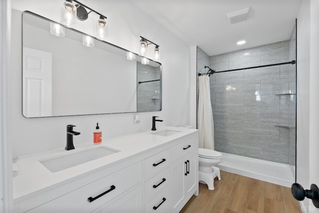 71 Patrick Ct, Madison Heights, VA 24572 - bathroom with toilet, a tile shower, double vanity, wood finished floors, and recessed lighting