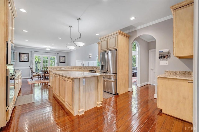 1037 Deer Hollow Rd, Forest, VA 24551 - kitchen with stainless steel appliances, light brown cabinets, ornamental molding, arched walkways, and wood-type flooring