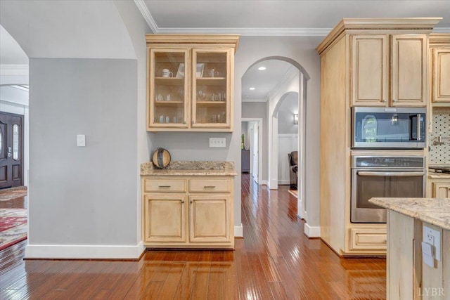 1037 Deer Hollow Rd, Forest, VA 24551 - kitchen with appliances with stainless steel finishes, arched walkways, light brown cabinetry, baseboards, and hardwood / wood-style floors