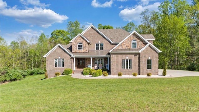 1037 Deer Hollow Rd, Forest, VA 24551 - view of front of house with covered porch, a front lawn, brick siding, and a standing seam roof