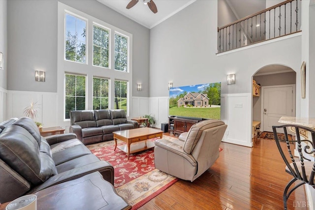 1037 Deer Hollow Rd, Forest, VA 24551 - living area featuring high vaulted ceiling, arched walkways, a ceiling fan, a wainscoted wall, and wood finished floors
