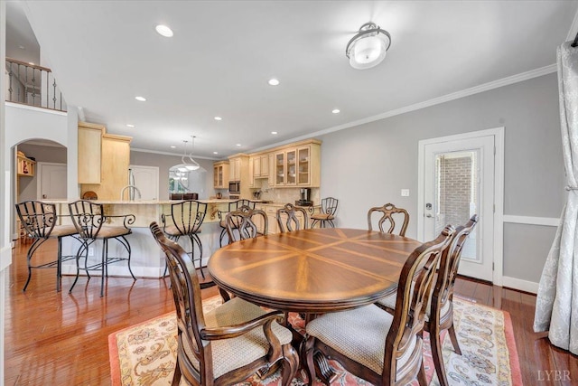 1037 Deer Hollow Rd, Forest, VA 24551 - dining area featuring crown molding, arched walkways, light wood-style floors, recessed lighting, and baseboards