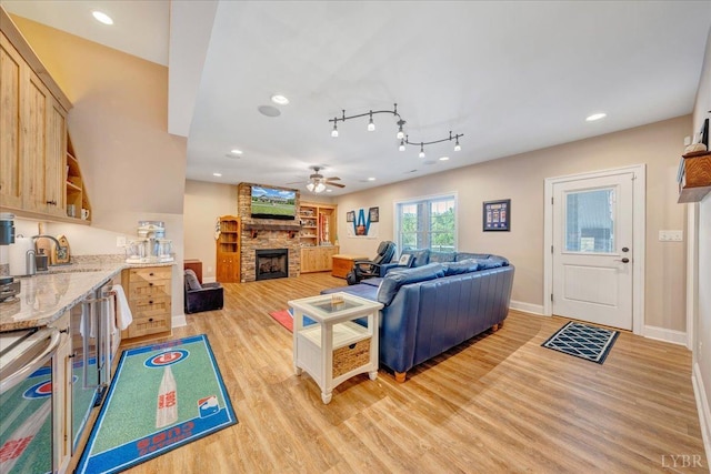20438 Wyatts Way, Evington, VA 24550 - living room with light wood-style flooring, a ceiling fan, a fireplace, recessed lighting, and baseboards