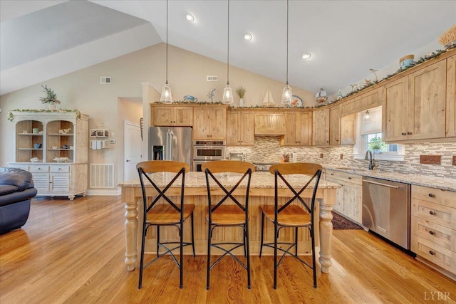 20438 Wyatts Way, Evington, VA 24550 - kitchen with appliances with stainless steel finishes, a breakfast bar area, high vaulted ceiling, tasteful backsplash, and light stone countertops