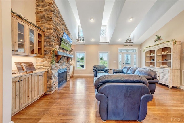 20438 Wyatts Way, Evington, VA 24550 - living area with light wood finished floors, a stone fireplace, high vaulted ceiling, baseboards, and recessed lighting