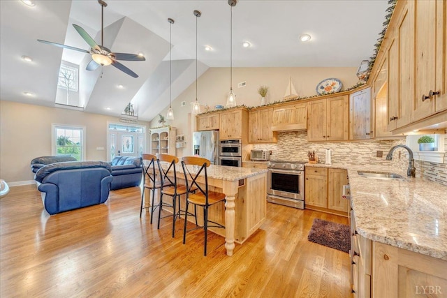 20438 Wyatts Way, Evington, VA 24550 - kitchen with appliances with stainless steel finishes, a sink, a ceiling fan, light brown cabinets, and high vaulted ceiling