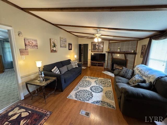 3164 Trent Hatchery Rd, Appomattox, VA 24522 - living room featuring wood finished floors, ceiling fan, a fireplace, and baseboards