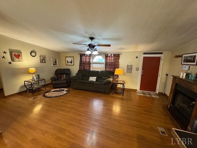 3164 Trent Hatchery Rd, Appomattox, VA 24522 - living room with ceiling fan, a glass covered fireplace, wood finished floors, and baseboards