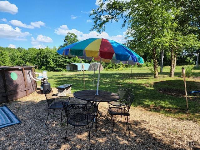 3164 Trent Hatchery Rd, Appomattox, VA 24522 - view of patio / terrace with an outdoor structure, a shed, and outdoor dining space