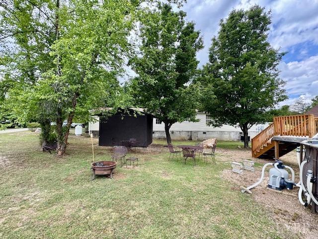 3164 Trent Hatchery Rd, Appomattox, VA 24522 - view of grassy yard featuring a fire pit, an outdoor structure, and stairs