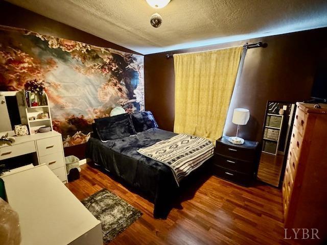 3164 Trent Hatchery Rd, Appomattox, VA 24522 - bedroom with wood finished floors and a textured ceiling