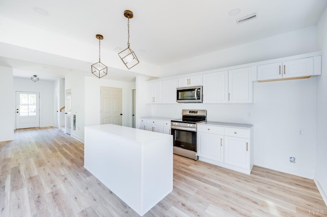303 Westover Blvd, Lynchburg, VA 24501 - kitchen featuring appliances with stainless steel finishes, white cabinetry, light countertops, and light wood finished floors
