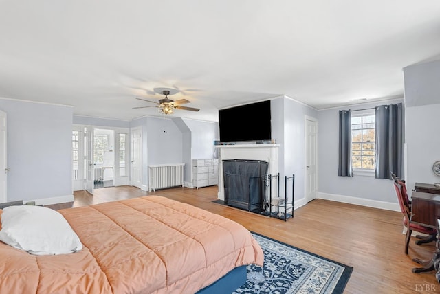 39 N Princeton, Lynchburg, VA 24503 - bedroom featuring radiator, crown molding, wood finished floors, a fireplace with flush hearth, and ceiling fan
