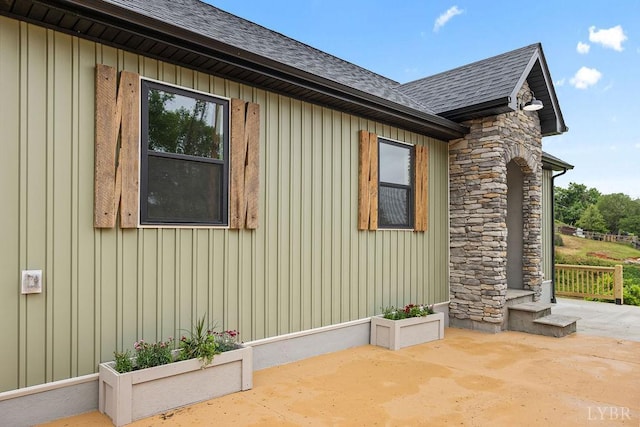 2127 Elm St, Lynchburg, VA 24504 - view of side of property with a patio, a shingled roof, stone siding, and board and batten siding