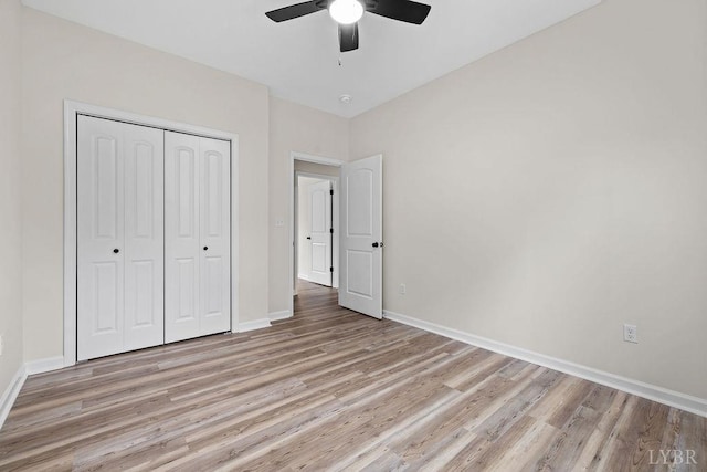 2127 Elm St, Lynchburg, VA 24504 - unfurnished bedroom with light wood finished floors, baseboards, a closet, and a ceiling fan
