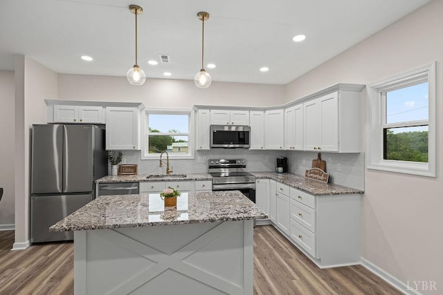 2127 Elm St, Lynchburg, VA 24504 - kitchen featuring appliances with stainless steel finishes, a sink, decorative backsplash, white cabinets, and recessed lighting