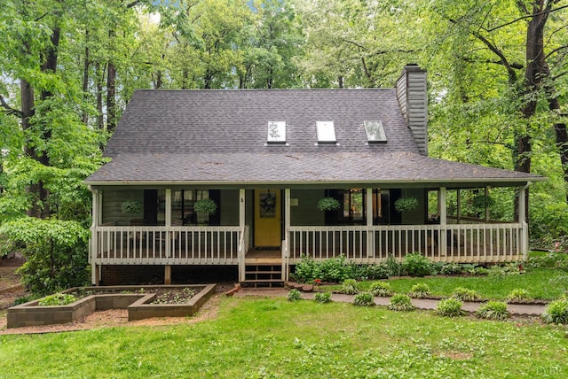 farmhouse featuring a chimney, a front lawn, a porch, and roof with shingles