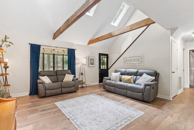 living room featuring baseboards, high vaulted ceiling, light wood-style floors, a skylight, and beamed ceiling