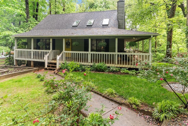 farmhouse inspired home with a chimney, a porch, a front lawn, and a shingled roof