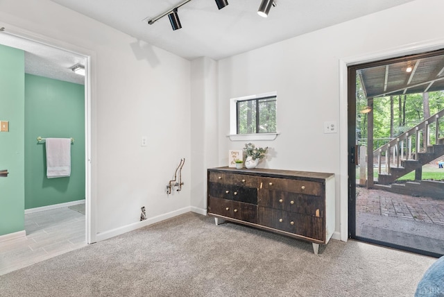 carpeted bedroom with access to outside, baseboards, and connected bathroom