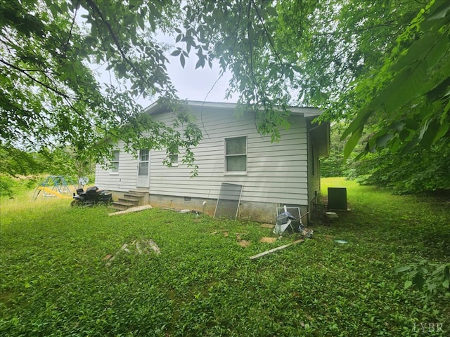 view of side of home with crawl space, entry steps, and a playground