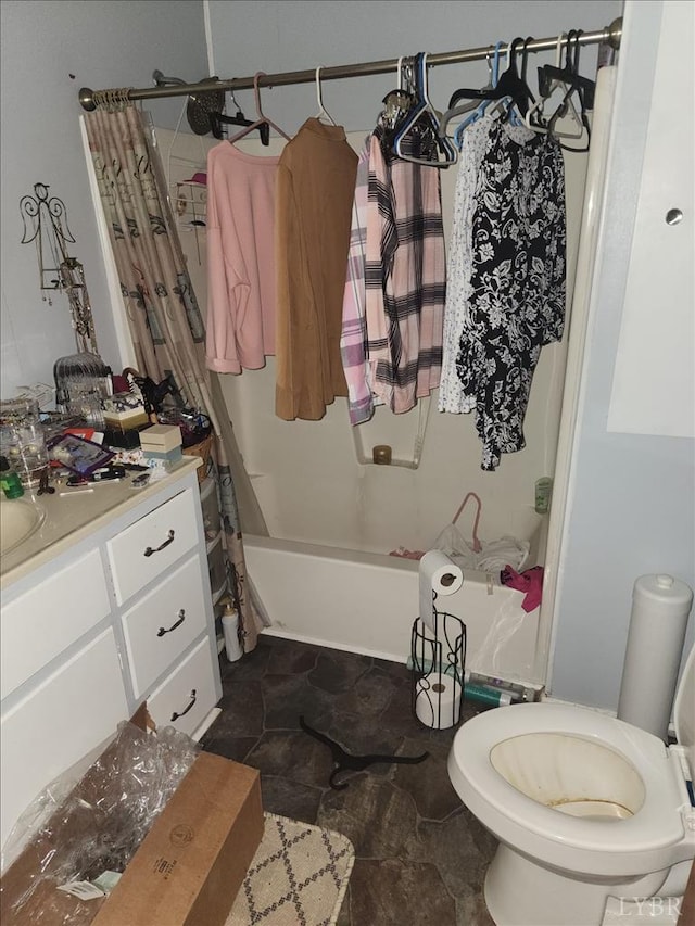 full bath with vanity, shower / bath combination with curtain, toilet, and stone finish flooring