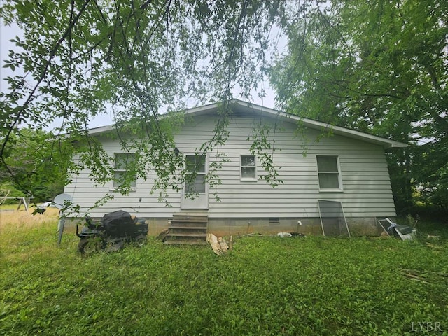 back of house with entry steps and crawl space