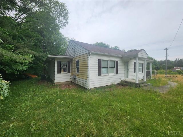 view of side of home with a yard