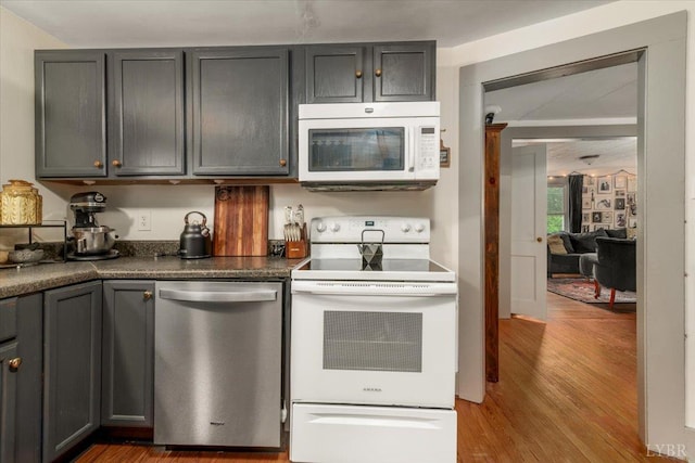 1920 Roxbury St, Lynchburg, VA 24501 - kitchen featuring white appliances, wood finished floors, dark countertops, and gray cabinets