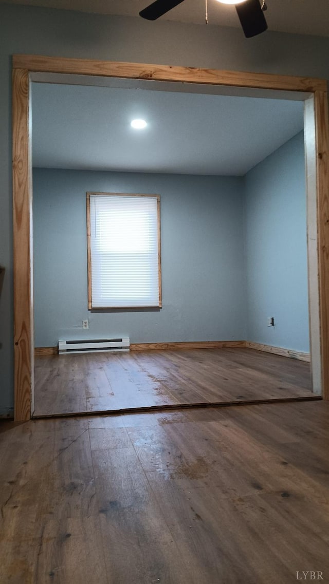 801 Henry St, Gretna, VA 24557 - spare room with baseboard heating, hardwood / wood-style floors, and ceiling fan