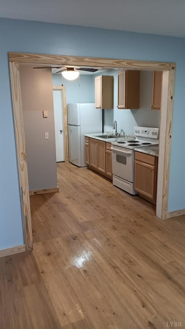 801 Henry St, Gretna, VA 24557 - kitchen featuring white appliances, light wood-style flooring, a sink, baseboards, and light countertops