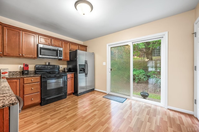 1810 Broadway St Unit 211, Lynchburg, VA 24501 - kitchen with appliances with stainless steel finishes, light wood-style flooring, and brown cabinetry