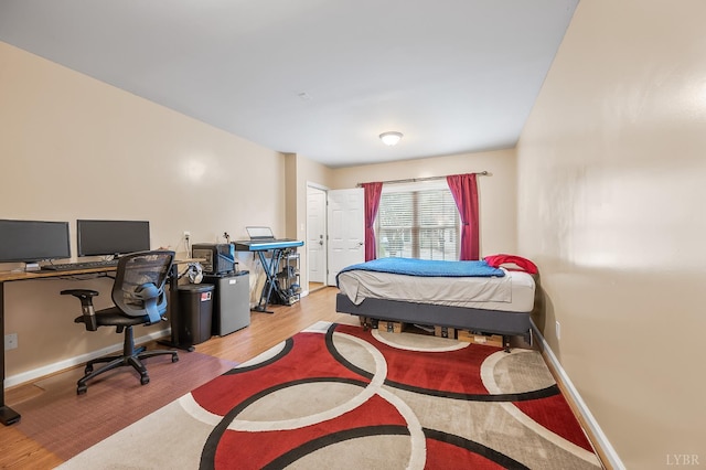 1810 Broadway St Unit 211, Lynchburg, VA 24501 - bedroom with wood finished floors, a desk, and baseboards