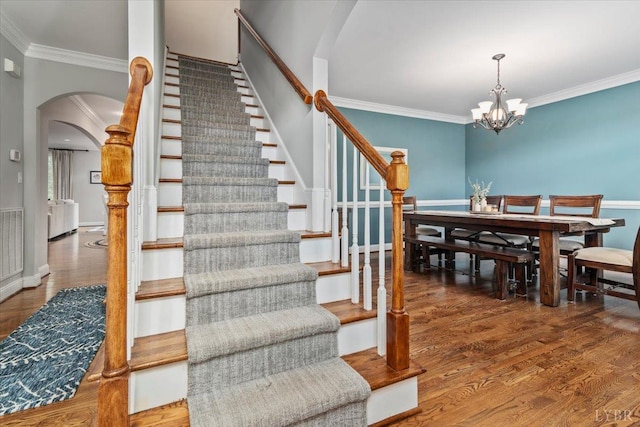 101 Trinity Ct, Lynchburg, VA 24502 - stairway featuring arched walkways, ornamental molding, wood finished floors, a chandelier, and baseboards